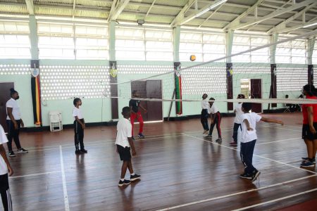 More than 100 youths between the ages of 7-16 are participating in the Guyana Defence Force’s inaugural Sports Summer Camp, which is being hosted at Base Camp Ayanganna, Thomas Lands. Here, some of them are in a game of volleyball. (GDF photo)
