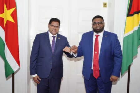 President Irfaan Ali (right) and Surinamese President Chandrikapersad Santokhi during one of their several meetings. The two presidents had cleared the way for the SK licences.
