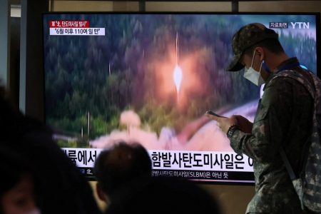 A South Korean soldiers walks past a TV broadcasting a news report on North Korea firing a ballistic missile towards the sea off its east coast, in Seoul, South Korea. (Reuters Photo)