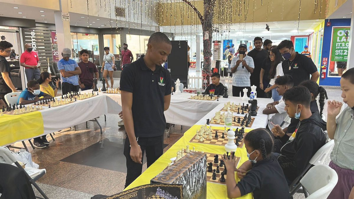 Anthony Drayton competing against several junior players in simultaneous chess matches