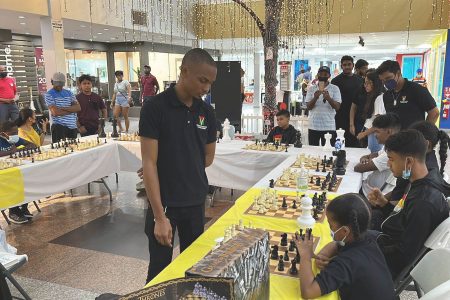 Anthony Drayton competing against several junior players in simultaneous chess matches