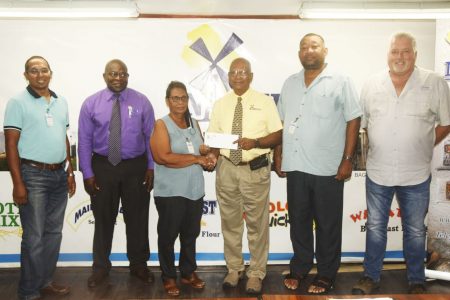 BCB Secretary, Angela Haniff, receives the sponsorship cheque from NAMILCO Managing Director Bert Sukhai in the presence of several officials including BCB president Hilbert Foster (2nd from right), Financial Controller Fitzroy McLeod (2nd from left), and Operations Manager Ralf Hemsing (1st from right)