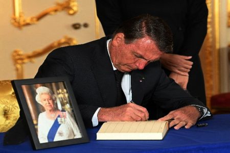 Brazilian President Jair Bolsonaro signs a book of condolence at Lancaster House in London, following the death of Queen Elizabeth II. Picture date: Sunday September 18, 2022. Jonathan Hordle/Pool via REUTERS