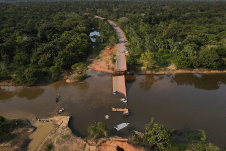 Locals and rescue workers navigate on boats at Curuca river after a bridge collapsed in BR-319 road in Careiro da Varzea, near Manaus, Brazil, September 28, 2022. REUTERS/Bruno Kelly