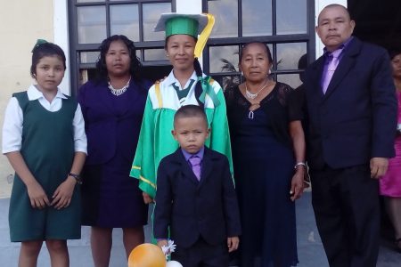 Colin De La Cruz with his wife Sharmayne (second, from left) daughter Kavita currently a UG student, his two other children and his mother