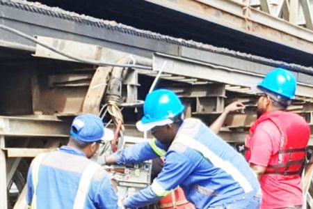 Engineering executing repair works on a damaged section of the bridge
