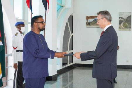 President Irfaan Ali (left) accepting the Letters of Credence from new EU Ambassador Rene van Nes. (Office of the President photo)