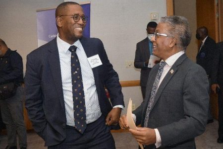 Chief Justice Ivor Archie, left, chats with Attorney General Reginald Armour during yesterday’s opening of the Caribbean Court of Justice’s first hemispheric meeting of regional courts, “The Rule of Law and International Justice”, at the Hyatt Regency, Port of Spain.