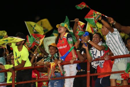 Super excited fans celebrate a Guyana Amazon Warriors win over the Barbados Royals last night at the Guyana National Stadium, Providence, East Bank Demerara. Warriors defended the score of 125 in 15 overs (GAW Photo) 