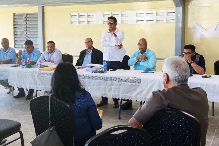 Attorney General and Minister of Legal Affairs Anil Nandlall (standing), flanked by Minister of Natural Resources Vickram Bharrat, Gas to Energy Project Lead Winston Brassington and Minister of Public Works Juan Edghill and other officials at the head table in the meeting with West Demerara landowners on Friday 
