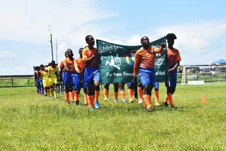 A scene from the March Past which occurred before the start of the Guyoil/Tradewind Tankers Secondary Schools Football League yesterday at the Ministry of Education ground, Carifesta Avenue.
