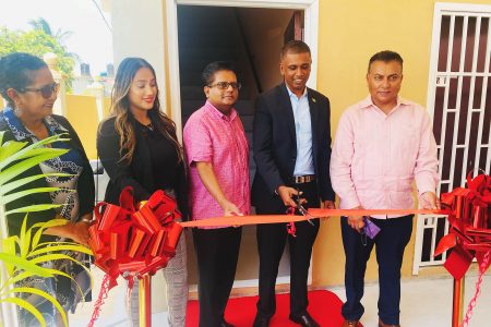 Chief Executive Officer (CEO) Ken Deocharran cuts the ribbon for the opening of the Express International Inc’s Henrietta branch

