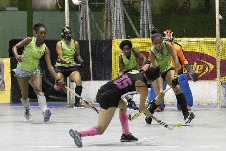 Sonia Jardine of GCC Tigers attempting a shot at goal against Woodpecker Hikers following a penalty corner in the Lucozade Indoor Hockey Championship