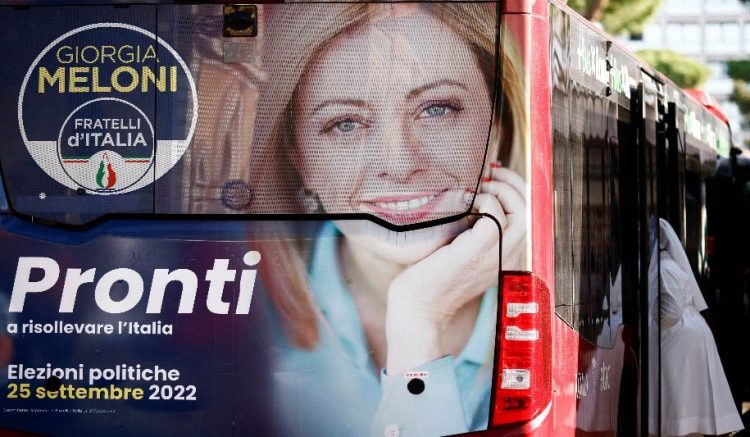 An election campaign poster of Giorgia Meloni, leader of the far-right Brothers of Italy party, is displayed on a bus ahead of the snap election of September 25, in Rome, Italy September 20, 2022. REUTERS/Yara Nardi