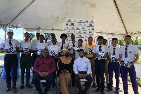 Representatives from the competing schools displaying their footballs which will aid in their preparation for the GuyOil/Tradewind Tankers Secondary Schools Football League. Also in the photo is Petra Organization Co-Director Troy Mendonca (sitting 1st from left), Tradewind Tankers Communication and Promotion Officer Saskia McClintock, (sitting-centre), and GuyOil representative Rajendra Rambarran