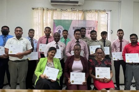 Participants with their certificates flanked by Bishwa Panday, President of the Insurance Institute of Guyana and Melissa DeSantos, President of the Insurance Association of Guyana