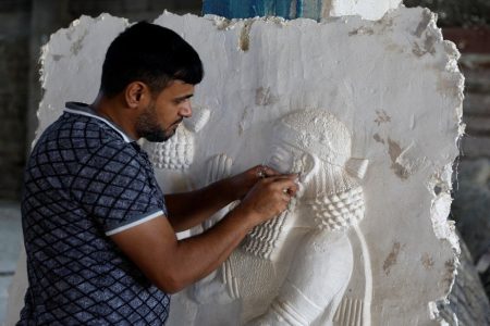 The sculptor Khaled al-Abadi works inside his workshop on his sculptures which depict scenes from the history of the city of Mosul, in Mosul, Iraq, September 15, 2022. REUTERS/Khalid al-Mousily