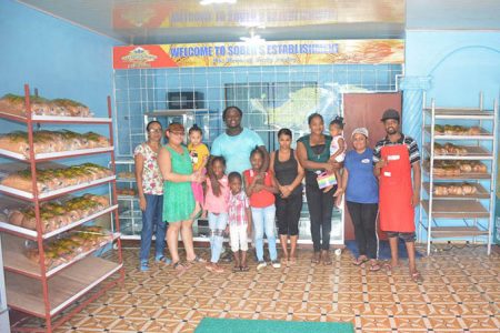 Troy Sobers surrounded with some of his staff and children