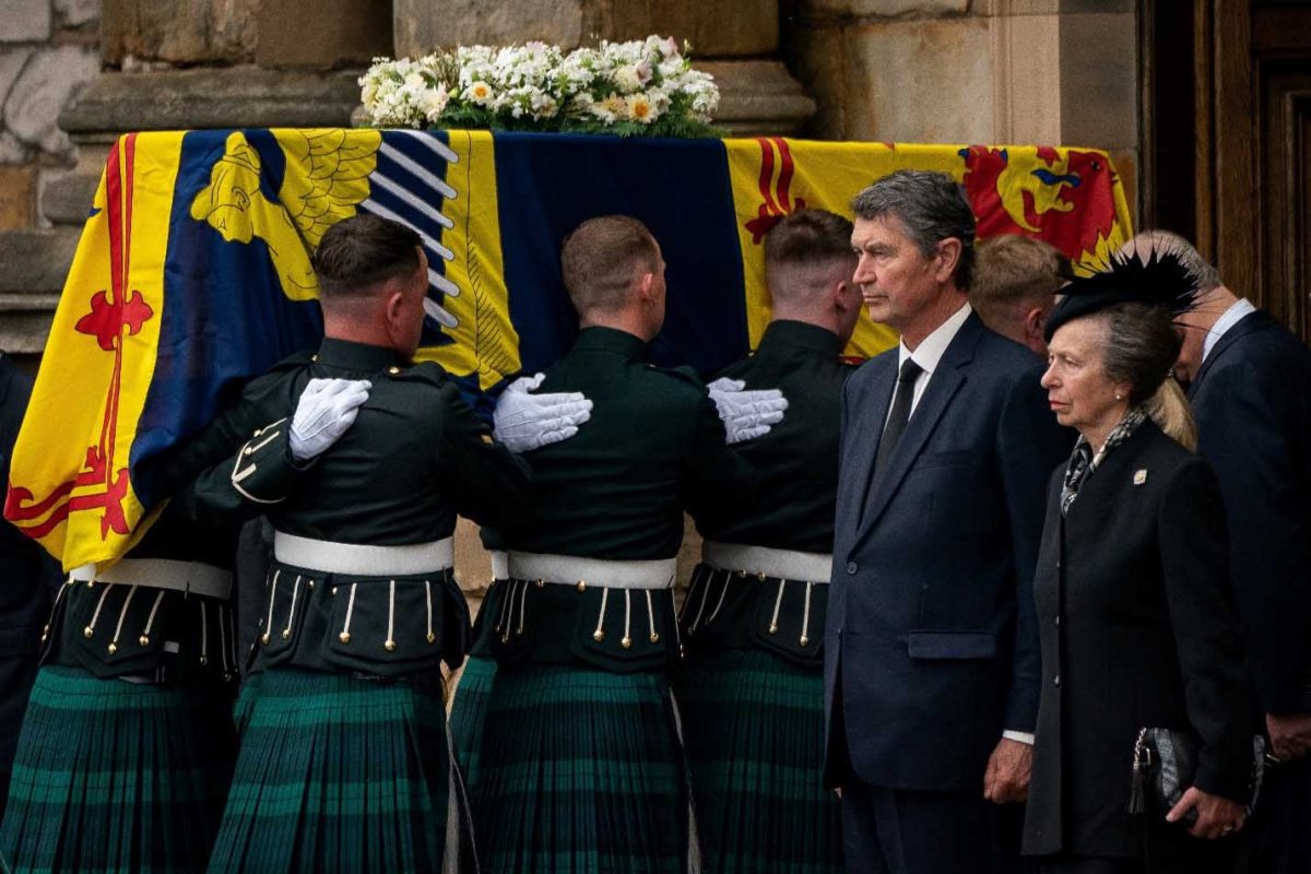 Vice Admiral Timothy Laurence and Britain’s Princess Anne stand solemnly as the coffin of Queen Elizabeth II, draped with the Royal Standard of Scotland, completes its journey from Balmoral to the Palace of Holyroodhouse, in Edinburgh, Scotland, Britain September 11, 2022. Aaron Chown/Pool via REUTERS
