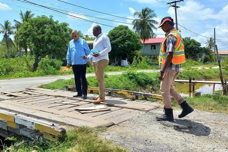 Minister of Public Works Juan Edghill (third from right) inspecting  a bridge in Buxton which is to be repaired. (Ministry of Public Works photo)