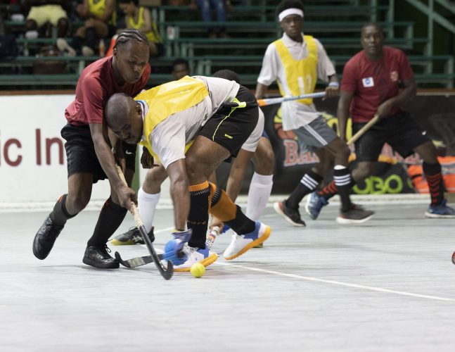 Scenes from the Saints Splinters and Old Fort (red) clash in the Lucozade Indoor Hockey Championship Thursday night.
