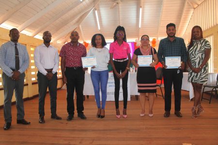 Some of the graduates with Education Ministry officials (Ministry of Education photo)