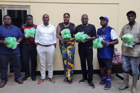 GFF President Wayne Forde (fourth from left) with members and representatives of clubs under the UDFA umbrella following the presentation of several footballs during an outreach programme Saturday.