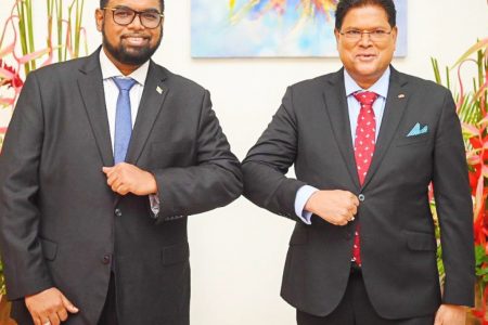 President Irfaan Ali (left) and Surinamese President Chandrikapersad Santokhi during a meeting