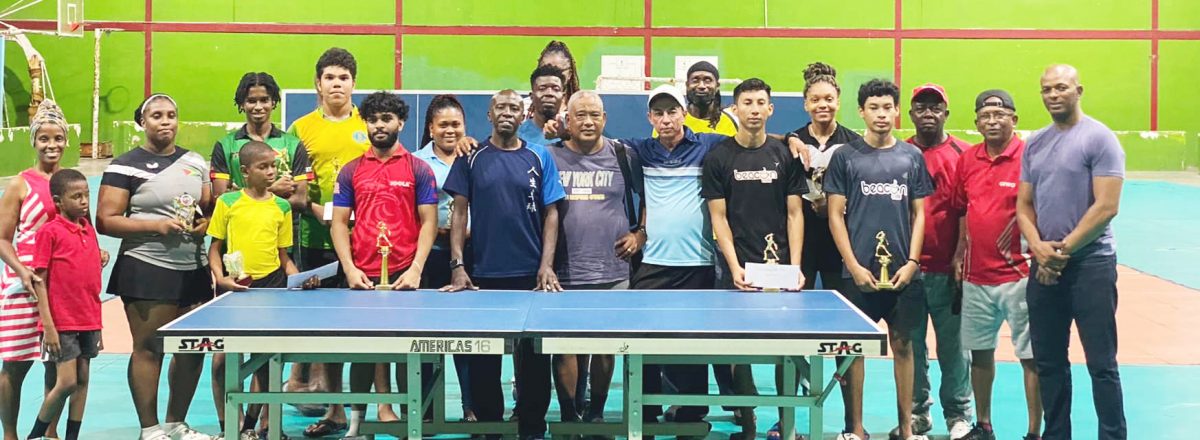 Former Caribbean men’s singles champion Sydney Christophe (in blue, centre) with the participants and officials following the conclusion of the tournament. (All photos courtesy GTTA/Ishaka Jackman)