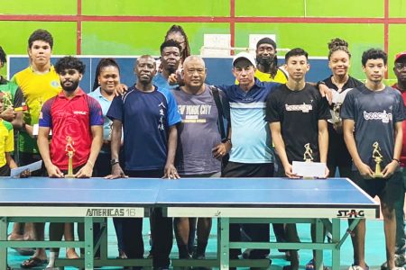 Former Caribbean men’s singles champion Sydney Christophe (in blue, centre) with the participants and officials following the conclusion of the tournament. (All photos courtesy GTTA/Ishaka Jackman)