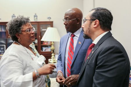 Prime Minister Keith Rowley (centre) chats with Prime Minister of Barbados, Mia Mottley (left) and Minister of Energy and Energy Industries and Minister in the Office of the Prime Minister,  Stuart Young before the hearing of the US House of Representatives Committee on Financial Services on the impacts of de-risking on banking in the Caribbean in Washington, DC yesterday.