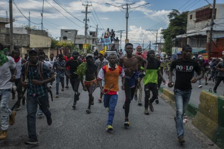 Protesters calling for the resignation of Haitian Prime Minister Ariel Henry run after police fired tear gas to disperse them in the Delmas area of Port-au-Prince, Haiti, Monday, Oct. 10, 2022. (AP Photo/Odelyn Joseph)(Odelyn Joseph / Associated Press)