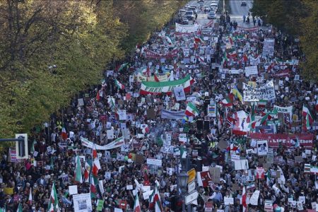 An aerial view shows people gathering in front of the Victory Column and holding banners and flags during a solidarity march for Iranian protests held following the death of Mahsa Amini, a 22 years old Iranian woman who died under custody by Iran's morality police for not wearing her hijab properly, on October 22, 2022 in Berlin, Germany.
