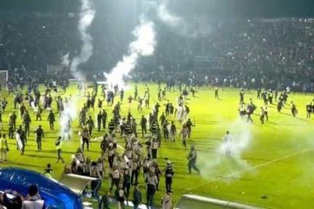 Fans invade the soccer field after a match between Arema FC and Persebaya Surabaya at Kanjuruhan Stadium, Malang, Indonesia Oct 2, 2022 in this screen grab taken from a REUTERS video.
