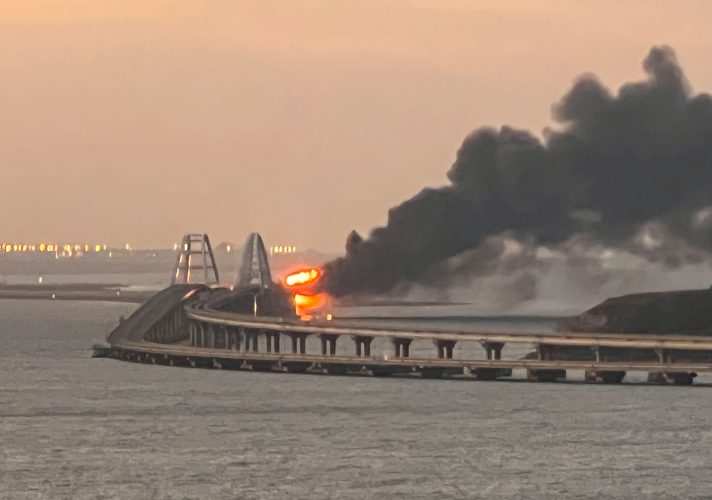A view shows a fire on the Kerch bridge at sunrise in the Kerch Strait, Crimea, October 8, 2022.  REUTERS/Stringer