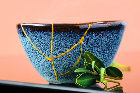 A bowl restored with gold along the cracks, using the traditional ‘kintsugi’ restoration technique