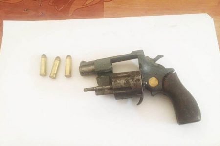 The firearm and ammunition that were allegedly found in the suspect’s possession. (Police photo)
