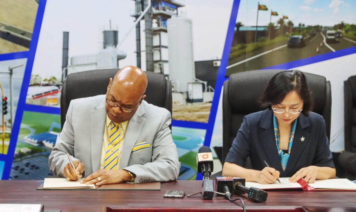 Minister of Public Works, Juan Edghill (left) and Ambassador of the People’s Republic of China to Guyana, Guo Haiyan yesterday afternoon signed the Air Service agreement. (DPI photo)