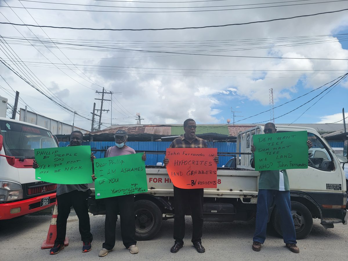 Elton McRae and other Beterverwagting residents protesting at the John Fernandes Limited wharf yesterday.
