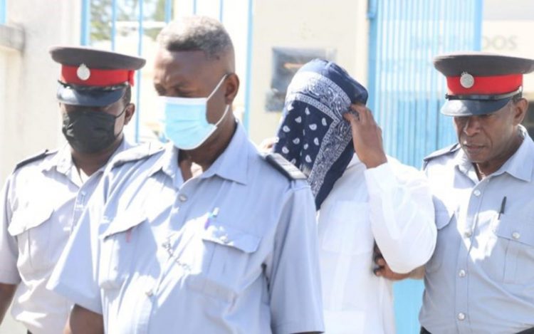 MP Neil Rowe being escorted out of court yesterday.