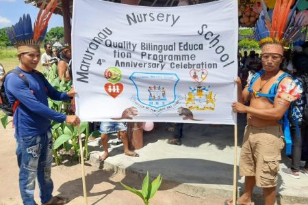 Maruranau Nursery School officials with a banner to celebrate the anniversary