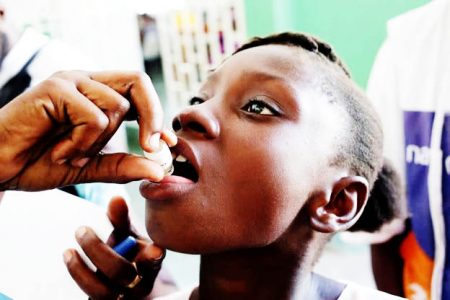 A girl receives an oral cholera vaccine at the Immaculate Conception Hospital in Les Cayes
