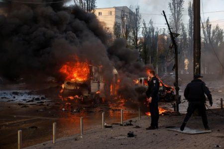Cars are seen on fire after Russian missile strikes on the capital, Kyiv [Valentyn Ogirenko/Reuters]