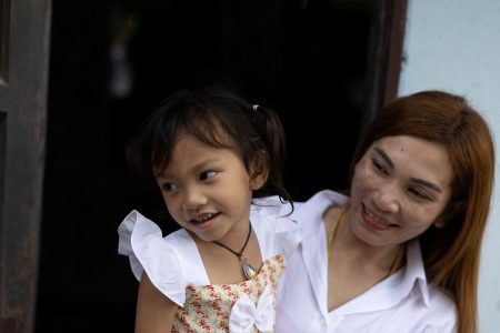 Panompai Sithong holds her 3-year-old daugther Paveenut Supolwong, nicknamed Ammy, who is the only child survivor of the day care centre mass shooting, during a family meeting at their home in Uthai Sawan, Nong Bua Lam Phu province, Thailand, October 9, 2022. REUTERS/Jorge Silva
