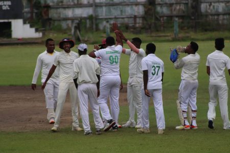 Christopher Barnwell celebrates the wicket of Aryan Persaud with his teammates yesterday. 