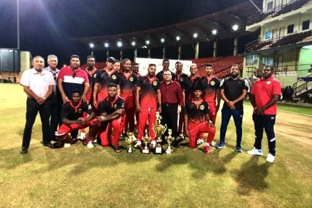 The  Berbice team poses with executives of the Guyana Cricket Board after retaining their 50-over Inter-County title yesterday at the Providence National Stadium.