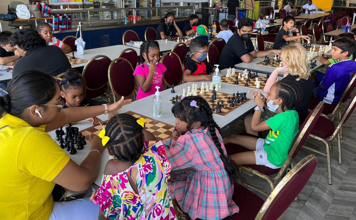 Students learning and playing chess at the School of the Nations on a Saturday morning.