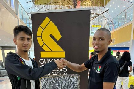 Chess master Anthony Drayton (right) congratulates top junior chess player Kyle Couchman following his victory in the recent simultaneous exhibition at the Giftland Mall (Photo: Shiv Nandalall)
