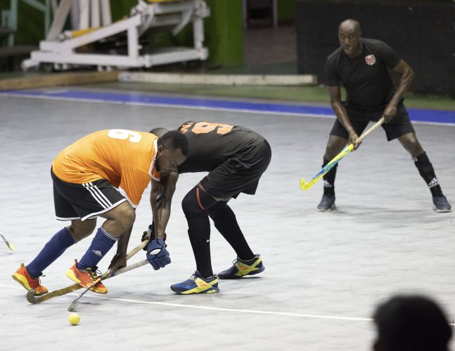 Bounty GCC’s Kevin Spencer (orange) battling for possession of the ball against an Old Fort player during their veteran’s matchup.Pix DSgcc29
