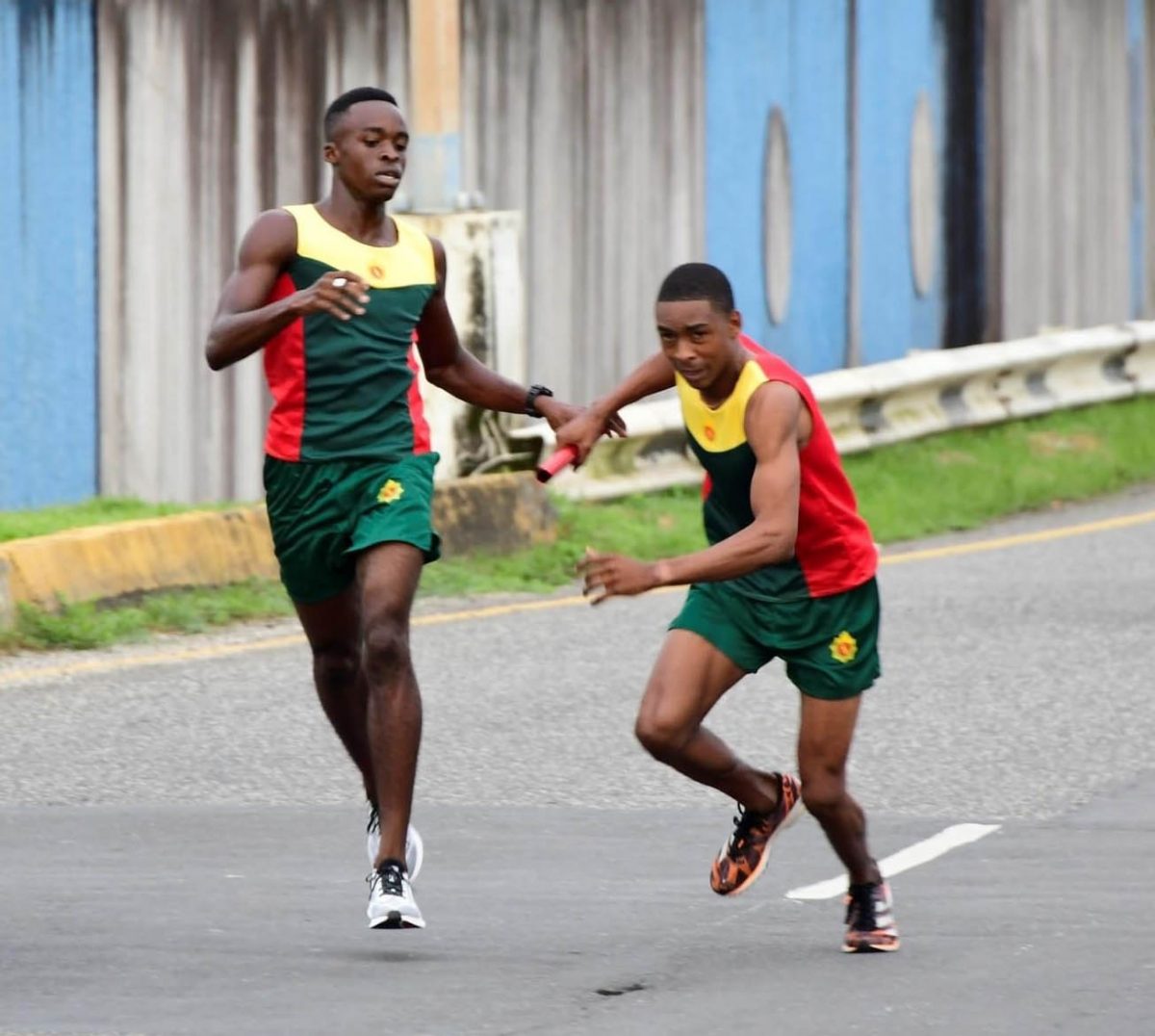 Matthew Gordon passing the baton to Marlon Nicholson on Sunday. The duo was part of the triumphant Guyana Defence Force (GDF) team which once again ran away with the first place trophy of the Inter-Services road relay event.
